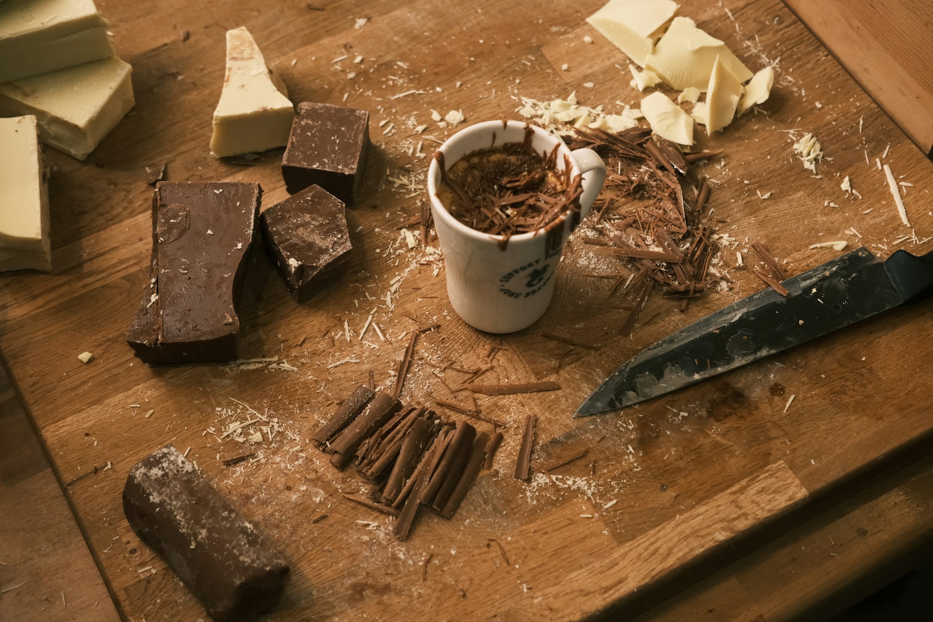 A wooden table topped with lots of different types of chocolate